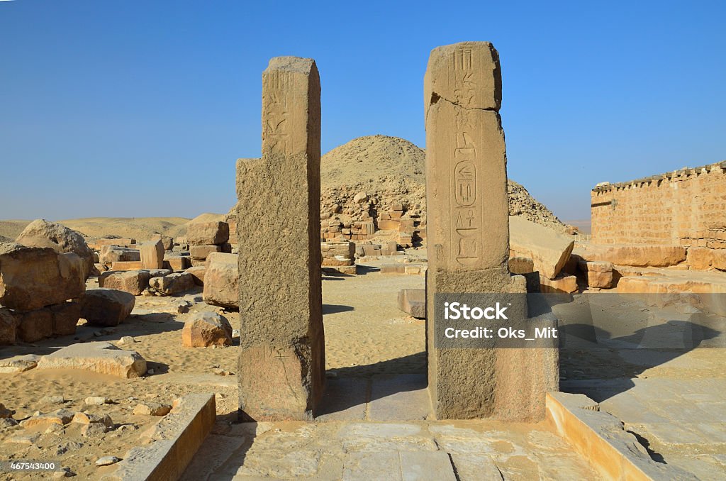 Ruins of the Egyptian temple, Saqqara necropolis An extant entrance of the ancient temple is situated in Saqqara necropolis, Giza, Egypt. 2015 Stock Photo