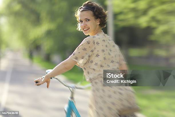 Girl In A Dress On A Bicycle Stock Photo - Download Image Now - 2015, Adult, Beautiful People