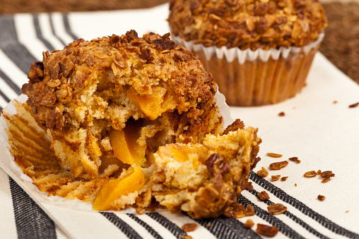 Crunchy Granola Peach Muffins with Butter Pecan Toppings. Selective focus.