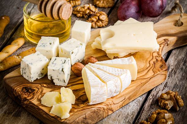 istock Emmental, Camembert, Parmesan, blue cheese, with walnuts and honey 467544214