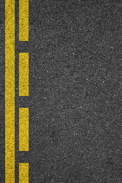 istock One side of an asphalt road with a yellow line 467545178