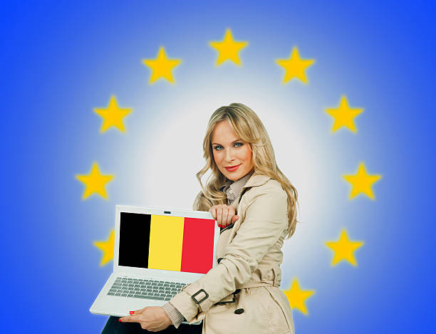 istock woman holding laptop with belgium flag 467545485