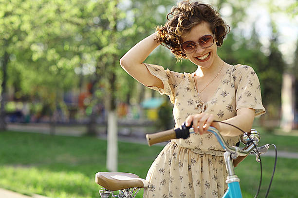 istock girl in a dress on a bicycle 467545730