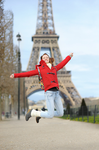 Young beautiful woman in Paris having fun near the Eiffel tower