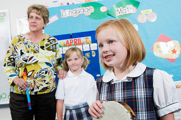 istock Teacher With Students In Music Class 467548966