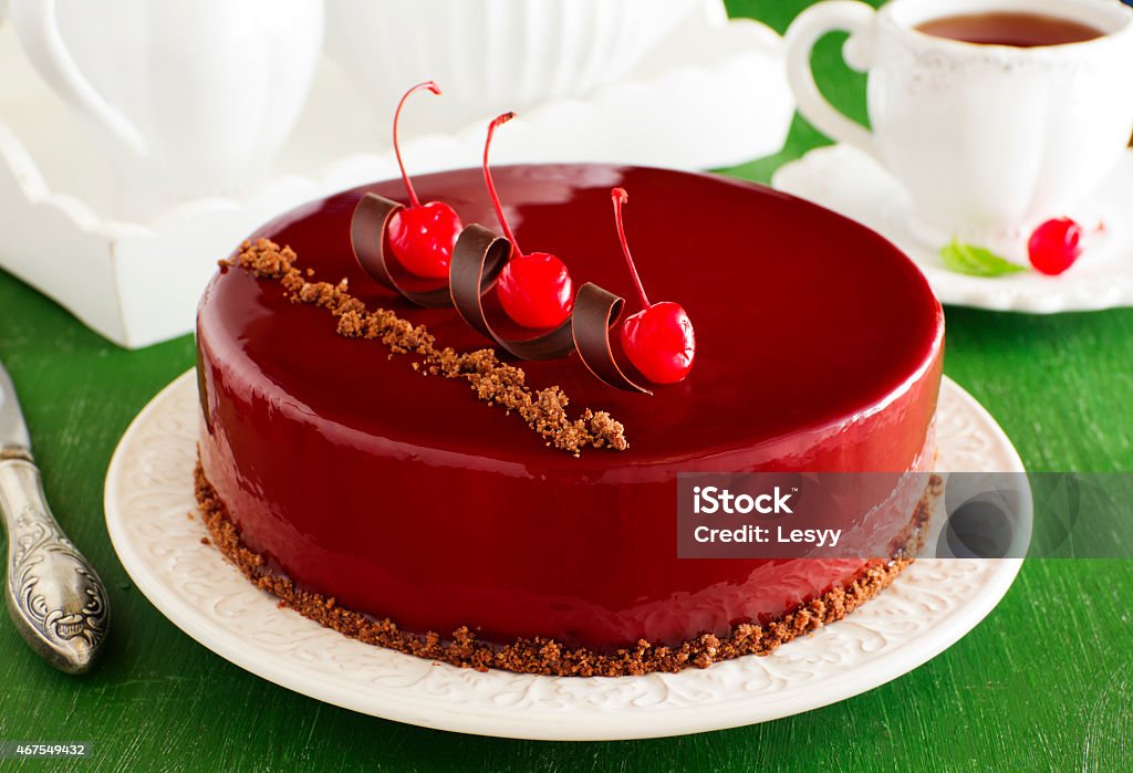 Chocolate cherry cake covered with a mirror coating. Chocolate cherry cake covered with a mirror coating.Chocolate cherry cake covered with a mirror coating. 2015 Stock Photo