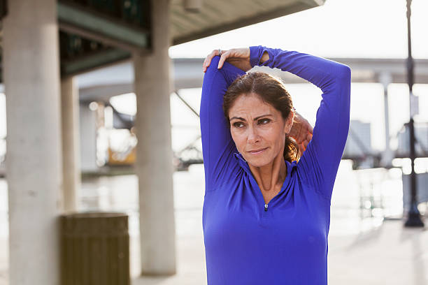 istock Mature woman stretching during a jog on waterfront 467549726