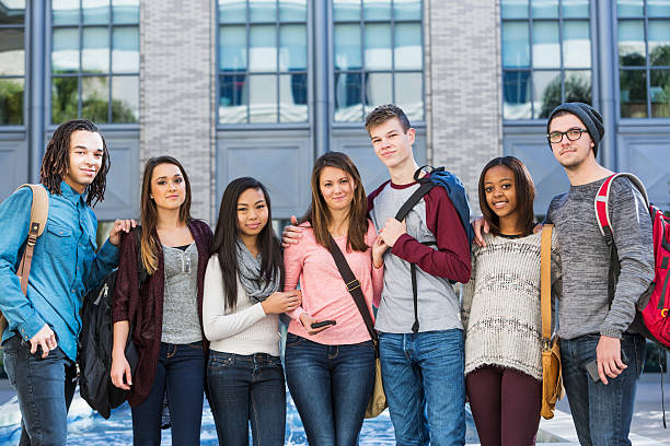 istock Group of students standing in a row outdoors 467549786