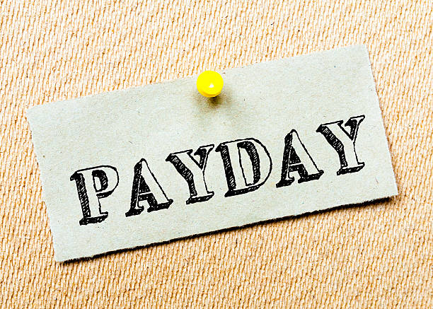 istock Recycled paper note pinned on cork board.Payday Message 467551198