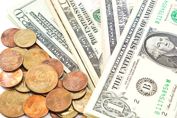istock Us dollar bills and coins on white background. 467552560