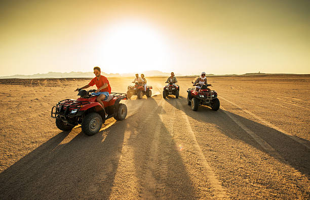 istock Friends driving quad bikes in the desert at sunset. 467552736