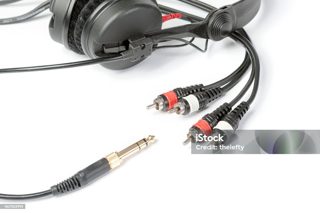 Headphones and jack plugs Headphones and golden jack plug isolated on white ground 2015 Stock Photo