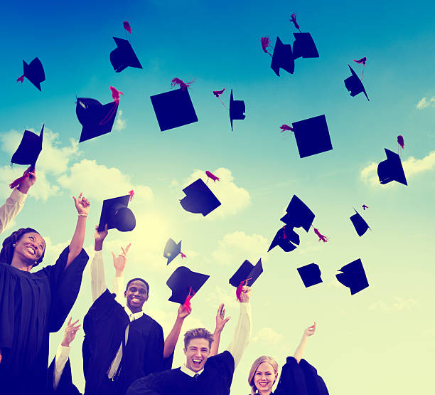 istock Graduation Caps Throwing Air Concept 467553084