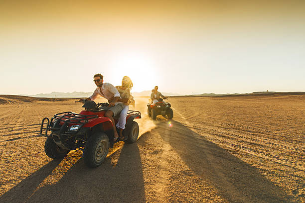 istock Happy friends driving quad bikes in the desert. Copy space. 467553104