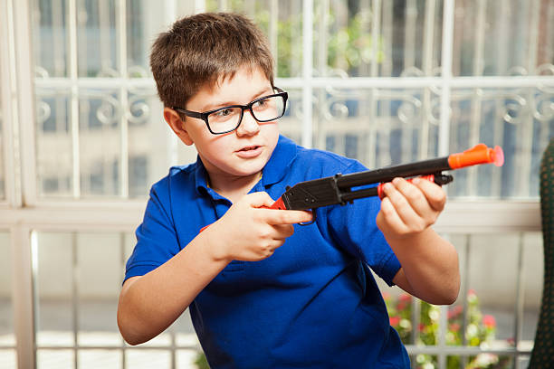 istock Kid shooting a toy gun 467553222