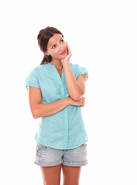 istock Young woman holding chin and looking up 467558112
