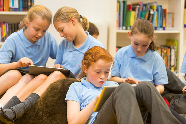 istock Group of school girls using tablet computers in the library 467558202