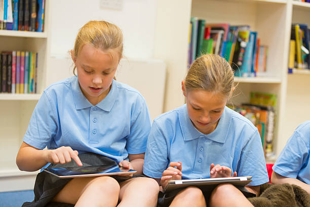 istock Group of school girls using tablet computers in the library 467558210