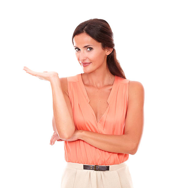 istock Charming woman smiling and holding palm up 467558326