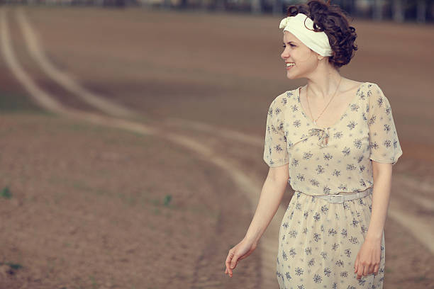 istock girl on the road in a field 467558682