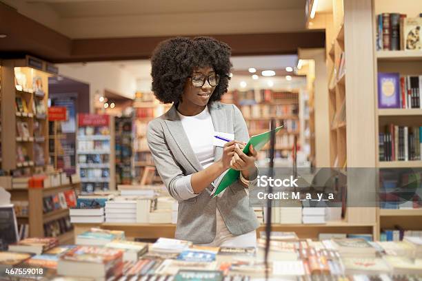 Women Working At Bookstore Stock Photo - Download Image Now - 2015, Adult, Adults Only