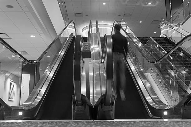 istock bw photo of man on an escalator 467559898