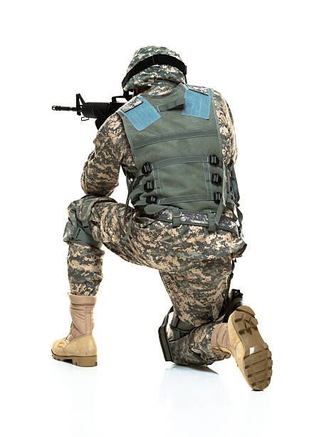 istock Rear view of army man kneeling and aiming 467560405