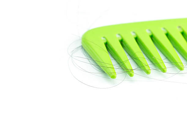 istock Green comb with hair 467561418