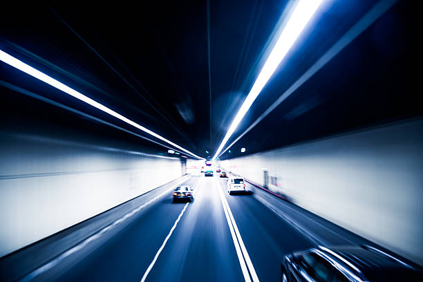 istock Truck light trails in tunnel 467561528