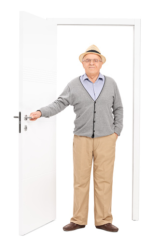 Portrait of a mid adult man opening the door