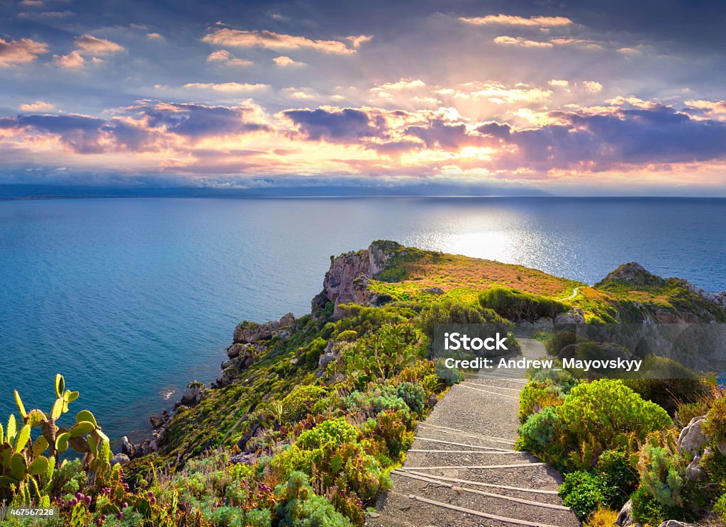 Colorful spring sunset on the cape Milazzo Colorful spring sunset on the cape Milazzo, nature reserve Piscina di Venere, Sicily, Italy, Tyrrhenian sea, Europe. Sicily Stock Photo