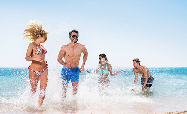 istock Happy young couples having fun in the sea. 467568576