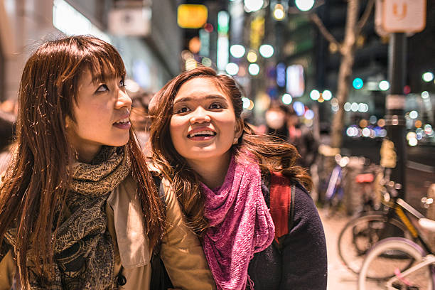 istock Asiatic friends togetherness on Tokyo by night 467571164
