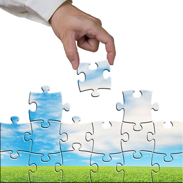 istock Hand holding puzzles to assembly with beautiful landscape 467571339
