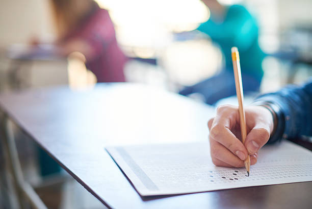 Taking a test Hand of student filling out answers to a test educational exam stock pictures, royalty-free photos & images