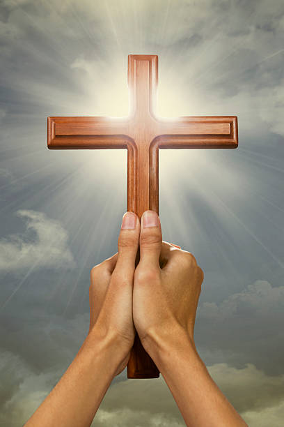 istock Prayer raise a cross wood to the sky 467573826