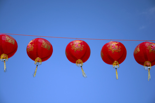 London, UK - February 2, 2014: Red Chinese Lanterns against a blue sky, the hanging lanterns are a traditional decorations marking the start of the Chinese New Year which is also known as the Lunar New Year.