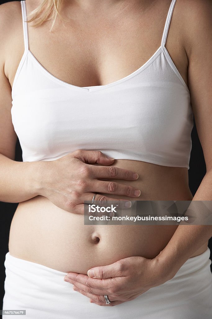 Close Up Portrait Of 4 months Pregnant Woman Close Up Portrait Of 4 months Pregnant Woman On Black Background 30-39 Years Stock Photo