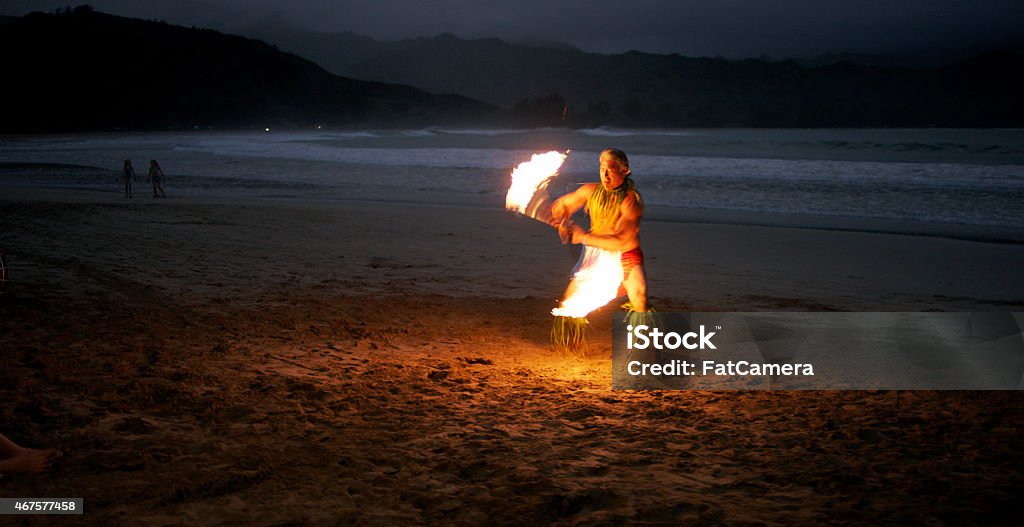 Traditional Hula Dance Traditional Hawaii performer dancing on the beach near the waters edge, twirling a flaming baton. Big Island - Hawaii Islands Stock Photo
