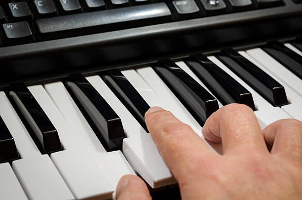 istock piano, key board bieng played colour image 467577722