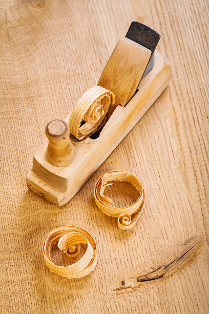 istock woodworkers plane with wooden chips on board 467578508