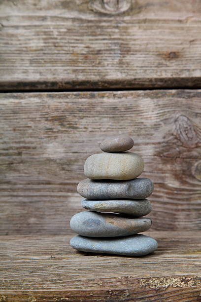 istock Stones on wooden background 467578794