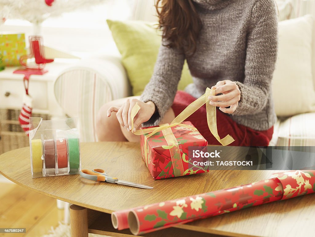 Close-Up of Woman Wrapping Christmas Presents Wrapping Paper Stock Photo
