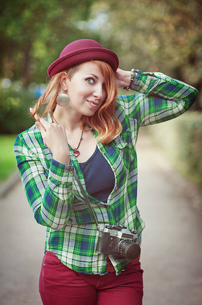 istock Cheerful hipster redhead girl in hat with retro camera 467582402