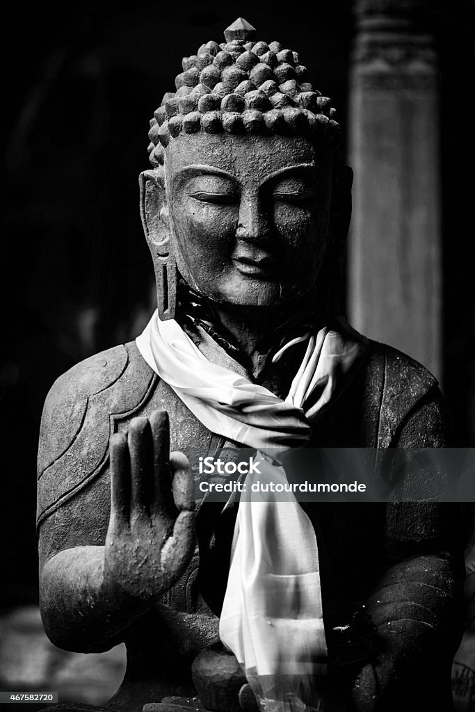 Buddha statue in black and white Wooden Buddha statue in black and white, kathmandu, Nepal 2015 Stock Photo