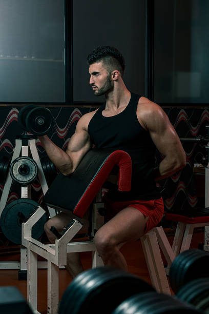 istock Men In Gym Exercising With Dumbbells 467583611