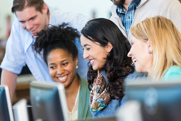 istock Diverse group of adults continuing education in library computer lab 467583742