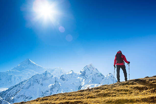 istock hiker at the top his hands raised enjoy sunny day 467583840