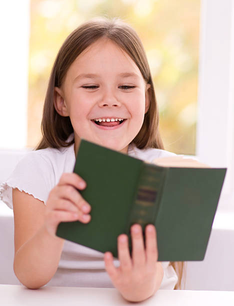 istock Little girl is reading a book 467584299