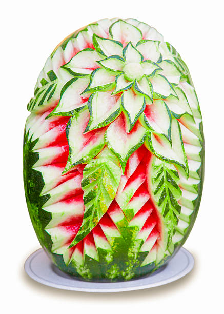 Watermelon carving like a flower petal sculpture on white background Fresh and organic water melon floral shape carved into petal sculpture isolated on white background on white dish with clipping path fruit carving stock pictures, royalty-free photos & images